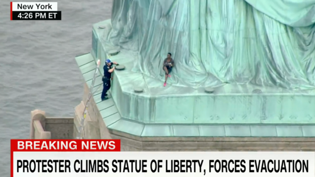 A Black Woman in Handcuffs For Climbing The Statue of Liberty on Independence Day is a Perfect Metaphor For America